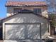 Two-story home featuring a two-car garage and a tile roof, offering great curb appeal at 1016 Vantage Point Rd, Las Vegas, NV 89128