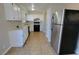Functional kitchen featuring white cabinets, tile floors, and stainless steel appliances at 1016 Vantage Point Rd, Las Vegas, NV 89128