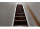 Staircase with wooden steps and a wooden handrail leading to the upper level at 1016 Vantage Point Rd, Las Vegas, NV 89128