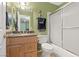 Bathroom featuring a well-maintained single vanity, and a shower over tub with a sliding glass door at 2040 Willowbury Dr # A, Las Vegas, NV 89108