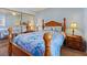 Bedroom featuring a wooden bed frame with mirrored closet doors reflecting light in the sleeping area at 2040 Willowbury Dr # A, Las Vegas, NV 89108