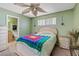 Bedroom showing green walls, a ceiling fan, and access to an attached bathroom with adjacent mirrored closet at 2040 Willowbury Dr # A, Las Vegas, NV 89108