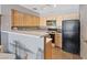 This kitchen features essential appliances, light wood cabinets, and a breakfast bar at 2040 Willowbury Dr # A, Las Vegas, NV 89108