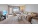 Cozy living room with plush carpeting, comfortable seating, and bright natural light at 2040 Willowbury Dr # A, Las Vegas, NV 89108