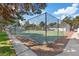Community tennis court with secure fencing offering a recreational space amidst trees and walkways at 2040 Willowbury Dr # A, Las Vegas, NV 89108