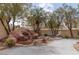This backyard oasis features a rock waterfall, lush landscaping, and a cozy fire pit area for outdoor enjoyment at 21 Ocean Harbour Ln, Las Vegas, NV 89148