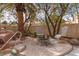 Backyard seating area near a stone waterfall with a charming fire pit perfect for outdoor entertaining at 21 Ocean Harbour Ln, Las Vegas, NV 89148