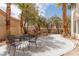 Lush backyard with a water feature, mature trees, and patio, creating a tranquil outdoor oasis at 21 Ocean Harbour Ln, Las Vegas, NV 89148
