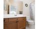 Bright bathroom features a wooden vanity, mirror, and shower-tub combo with decorative curtain at 21 Ocean Harbour Ln, Las Vegas, NV 89148