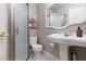 Elegant bathroom featuring a pedestal sink, a frosted glass enclosed shower, and modern fixtures at 21 Ocean Harbour Ln, Las Vegas, NV 89148