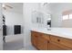 Bathroom with a spacious vanity, double mirrors, and an open doorway to the bedroom at 21 Ocean Harbour Ln, Las Vegas, NV 89148