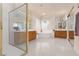 Well-lit bathroom with a glass-enclosed shower, and ample counter space with wood cabinetry at 21 Ocean Harbour Ln, Las Vegas, NV 89148