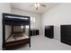 Simple bedroom with a bunk bed, two black dressers and a window with plantation shutters at 21 Ocean Harbour Ln, Las Vegas, NV 89148