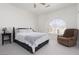 Bright bedroom featuring a king bed, an accent chair, and a large window with plantation shutters at 21 Ocean Harbour Ln, Las Vegas, NV 89148