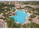 Aerial view of a sparkling community pool surrounded by palm trees offering a resort-style amenity at 21 Ocean Harbour Ln, Las Vegas, NV 89148