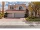 Charming two-story home featuring a three-car garage, landscaped yard, and a red tile roof at 21 Ocean Harbour Ln, Las Vegas, NV 89148