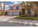 Charming two-story home featuring a three-car garage, landscaped yard, and a red tile roof at 21 Ocean Harbour Ln, Las Vegas, NV 89148