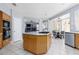Bright eat-in kitchen features an island, stainless steel appliances, tile floors and backyard views at 21 Ocean Harbour Ln, Las Vegas, NV 89148