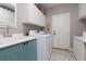 Bright laundry room featuring a sink, cabinetry, and modern washer and dryer units at 21 Ocean Harbour Ln, Las Vegas, NV 89148