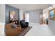 Bright and airy sitting area with comfortable seating, bookshelves and a decorative painting at 21 Ocean Harbour Ln, Las Vegas, NV 89148