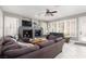 Spacious living room with a fireplace, television, ceiling fan, comfortable couches and light walls at 21 Ocean Harbour Ln, Las Vegas, NV 89148