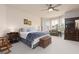 Cozy bedroom featuring a ceiling fan, neutral walls, and dark wood furniture at 21 Ocean Harbour Ln, Las Vegas, NV 89148