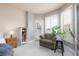 Comfortable bedroom corner with a cozy armchair and bright natural light from shuttered windows at 21 Ocean Harbour Ln, Las Vegas, NV 89148