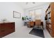 Home office with a wooden desk, shelving and bright natural light through the windows at 21 Ocean Harbour Ln, Las Vegas, NV 89148