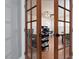 Home office with French doors, hardwood floors, and a ceiling fan for a comfortable workspace at 21 Ocean Harbour Ln, Las Vegas, NV 89148