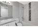 Bathroom featuring a sink, toilet, and a shower-tub with decorative tile accents at 220 Mission Catalina Ln # 207, Las Vegas, NV 89107