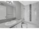 Clean bathroom showcasing a sink, toilet, and a shower-tub with decorative tile accents at 220 Mission Catalina Ln # 207, Las Vegas, NV 89107