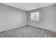Comfortable bedroom with gray carpet, neutral walls, and a bright window at 220 Mission Catalina Ln # 207, Las Vegas, NV 89107