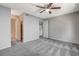 Spacious bedroom featuring plush gray carpeting, a ceiling fan, and neutral walls at 220 Mission Catalina Ln # 207, Las Vegas, NV 89107