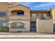 Condo building featuring stucco facade, private balconies, and desert landscaping at 220 Mission Catalina Ln # 207, Las Vegas, NV 89107