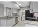 Well lit kitchen featuring stainless steel appliances, light grey counter tops, and a view to the living room at 220 Mission Catalina Ln # 207, Las Vegas, NV 89107