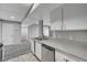 Well lit kitchen featuring stainless steel appliances, light grey counter tops, and a view to the living room at 220 Mission Catalina Ln # 207, Las Vegas, NV 89107