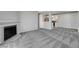 Open living room with fireplace and view into adjacent modern kitchen at 220 Mission Catalina Ln # 207, Las Vegas, NV 89107