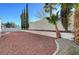 Landscaped backyard featuring desert landscaping, privacy walls, and mature trees, perfect for outdoor enjoyment at 2221 Loggerhead Rd, Las Vegas, NV 89117