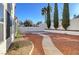 Beautifully landscaped backyard with mature trees, providing privacy and a serene outdoor space at 2221 Loggerhead Rd, Las Vegas, NV 89117