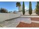 Secluded backyard featuring decorative rock landscaping, mature trees, and a private patio area at 2221 Loggerhead Rd, Las Vegas, NV 89117