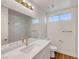 Bathroom features white cabinets, a large mirror, and modern fixtures at 2221 Loggerhead Rd, Las Vegas, NV 89117