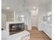 Primary bath with double vanity, fireplace, shower, and hardwood floors at 2221 Loggerhead Rd, Las Vegas, NV 89117