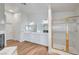 Bathroom featuring double sinks, walk-in shower, and hardwood floors at 2221 Loggerhead Rd, Las Vegas, NV 89117