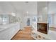 Bright bathroom featuring double sinks, tub, and a fireplace at 2221 Loggerhead Rd, Las Vegas, NV 89117