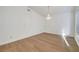 Vacant bedroom featuring light wood flooring, a chandelier and natural light at 2221 Loggerhead Rd, Las Vegas, NV 89117