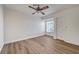 Bright bedroom features wood-look floors, a window, and ceiling fan at 2221 Loggerhead Rd, Las Vegas, NV 89117