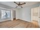 Spacious bedroom featuring wood floors, a window, and multiple doorways at 2221 Loggerhead Rd, Las Vegas, NV 89117
