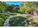 Well-maintained community park with trees, walkways, and landscaping at 2221 Loggerhead Rd, Las Vegas, NV 89117