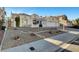 A beautiful single-story house featuring desert landscaping, a tile roof, and an attached three-car garage at 2221 Loggerhead Rd, Las Vegas, NV 89117