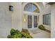 Double doors with decorative ironwork, and an arched window make this entry an impressive welcome at 2221 Loggerhead Rd, Las Vegas, NV 89117